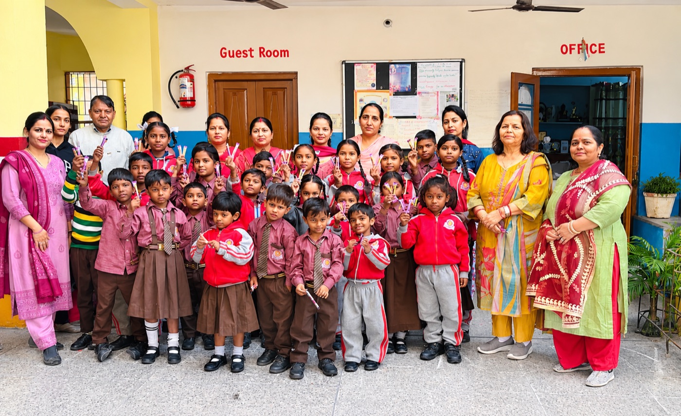 Teachers with young students outside the school office